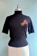 Pomegranate Turtleneck Sweater in Black by Banned