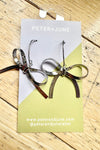 Silver Hot to Bow Earrings by Peter and June
