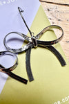 Silver Hot to Bow Earrings by Peter and June