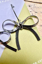 Silver Hot to Bow Earrings by Peter and June