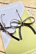 Silver Hot to Bow Earrings by Peter and June