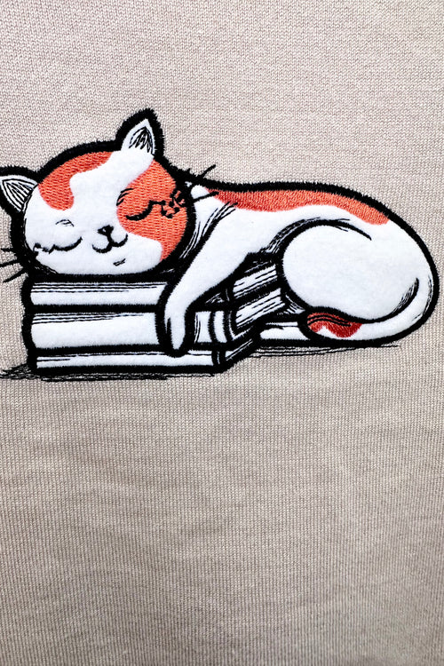 Cat Sleeping on Books Knit Pullover Sweater in Cream by Voodoo Vixen