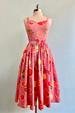Full skirt in pink with a print of pink and yellow grapefruit slices! Pair this with the matching top or   There are functioning buttons down the front and this skirt is not lined.    97% Cotton 3% Spandex