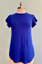 Super soft flutter sleeve top in a beautiful royal blue!  This top can be worn as a long tee, knotted, tucked in or layered under a dress.  So many possibilities in one tee!  This top has a shorter front than back.  VERY stretchy!    95% Rayon, 5% spandex